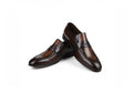 A pair of men's dark brown penny loafers with a glossy finish, displayed on a clean white background.
