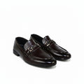 A pair of dark brown leather penny loafers with a polished metal horsebit detail across the vamp, shown on a plain white background.