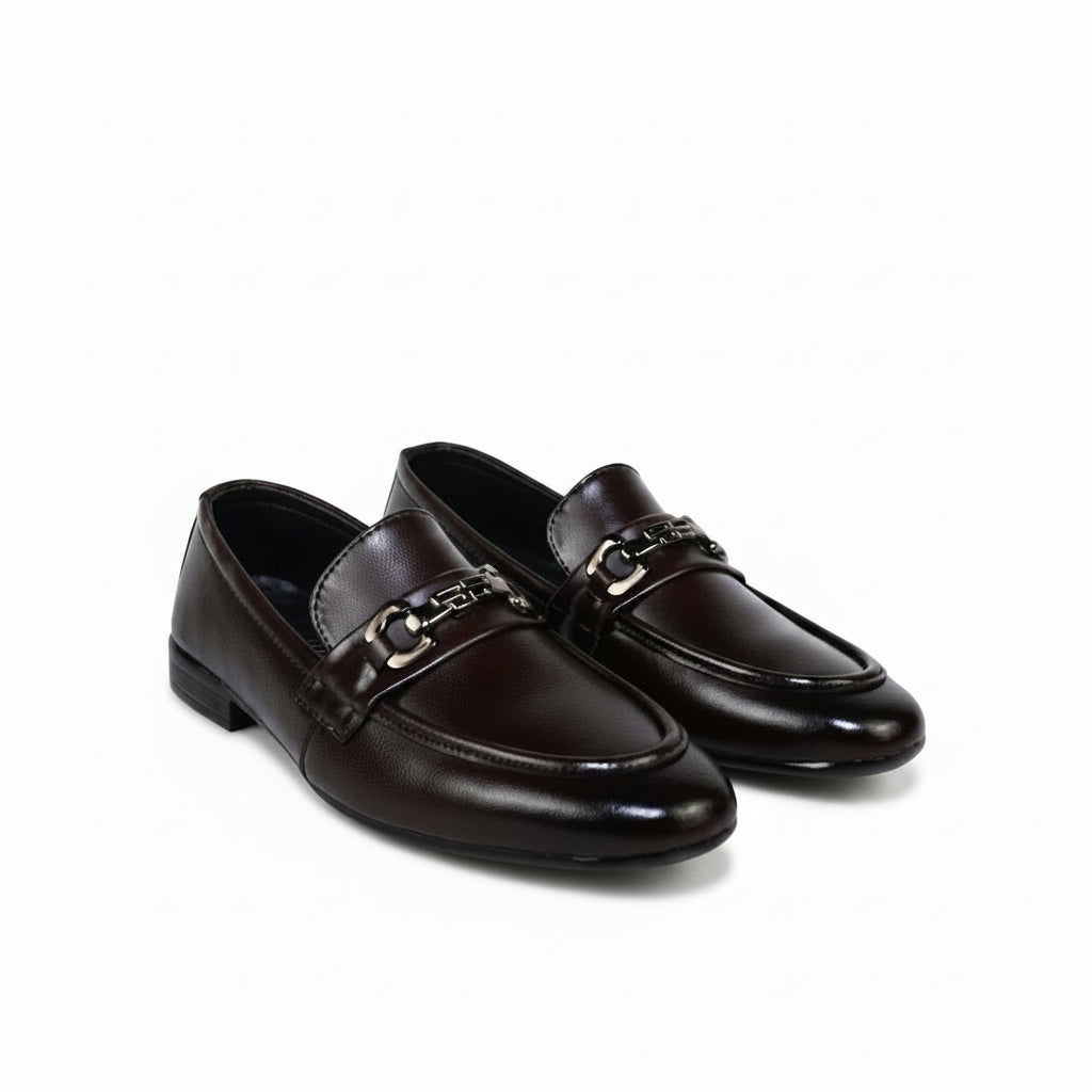A pair of dark brown leather penny loafers with a polished metal horsebit detail across the vamp, shown on a plain white background.