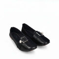 A pair of black leather flat shoes with square toes and silver buckle embellishments, displayed on a clean white background.