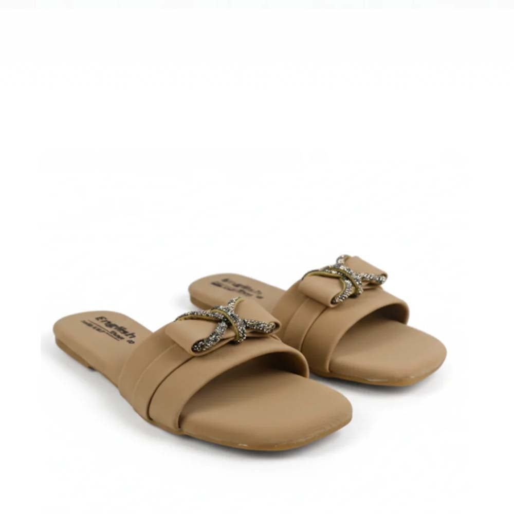 A pair of tan slide sandals with a decorative metallic star-shaped embellishment on the strap, shown on a plain white background.