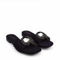 A pair of women's open-toe slide sandals in dark navy blue satin, featuring a square toe and a decorative oval buckle embellished with sparkling rhinestones. The brand name 'Fashions' is printed on the insole.