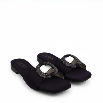 A pair of women's open-toe slide sandals in dark navy blue satin, featuring a square toe and a decorative oval buckle embellished with sparkling rhinestones. The brand name 'Fashions' is printed on the insole.