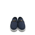A pair of navy blue suede slip-on loafers with a black leather strap and a gold lion emblem, set against a plain white background.