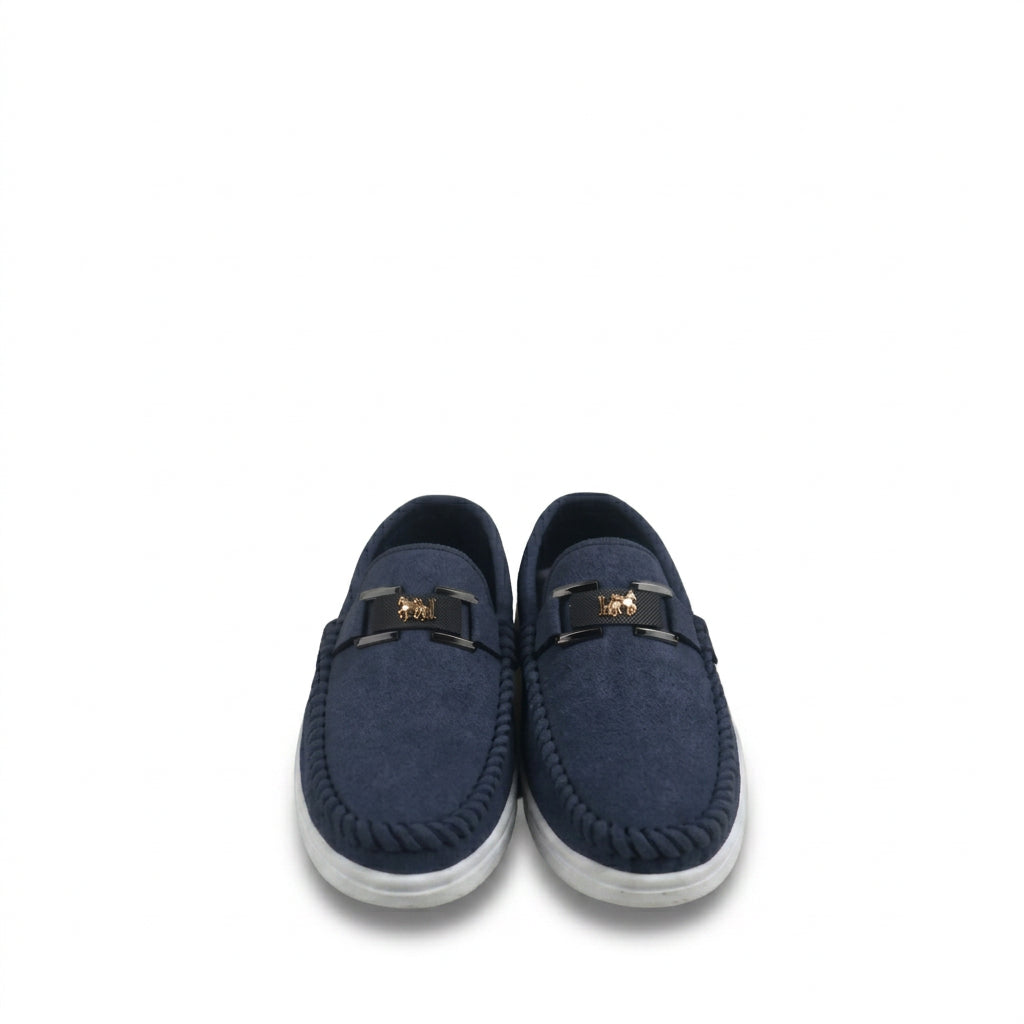 A pair of navy blue suede slip-on loafers with a black leather strap and a gold lion emblem, set against a plain white background.