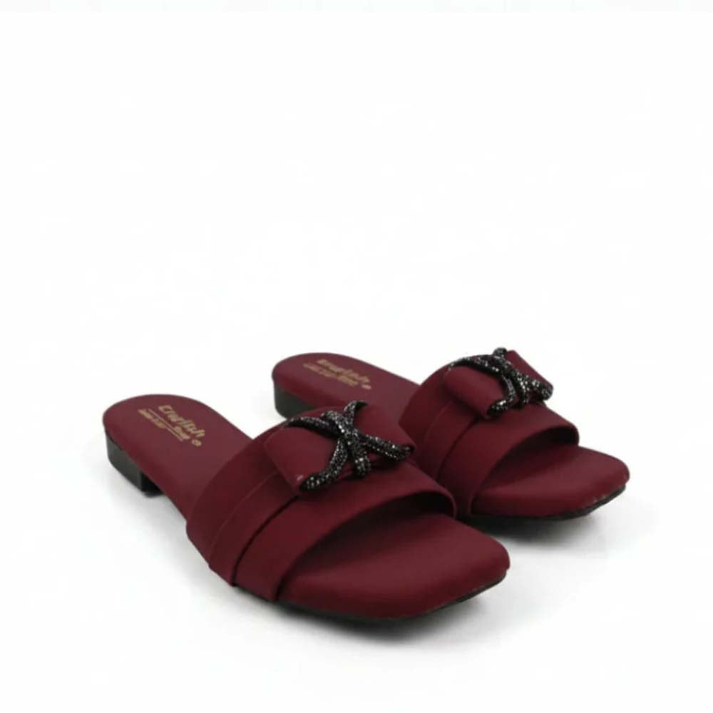A pair of women's open-toe slide sandals in deep burgundy, featuring a wide strap adorned with a black starfish embellishment covered in small clear rhinestones. The brand name 'SABINE' is printed in gold on the footbed.
