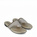 A pair of metallic gold slide sandals with glittery silver straps, shown on a plain white background.