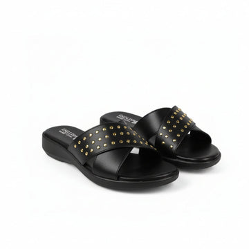 A pair of black slide sandals with gold-tone metal studs arranged in a crisscross pattern across the straps, shown on a plain white background.