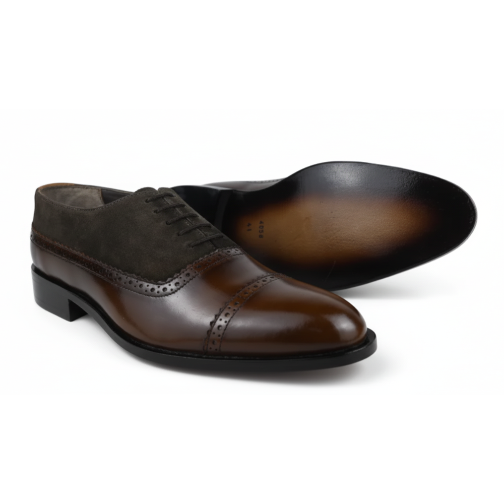 Pair of brown dress shoes on a white background