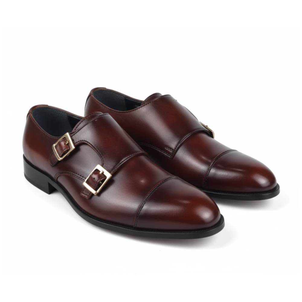A pair of men's dark brown leather double monk shoes with gold-tone buckle straps, shown on a clean white background.
