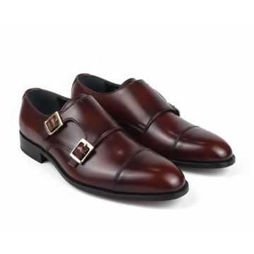 A pair of men's dark brown leather double monk shoes with gold-tone buckle straps, shown on a clean white background.
