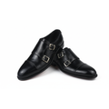 Pair of black leather shoes with buckles on a white background