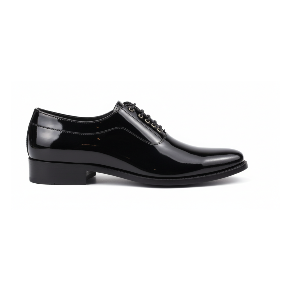 Person wearing black dress shoes and white pants in a blurred indoor setting