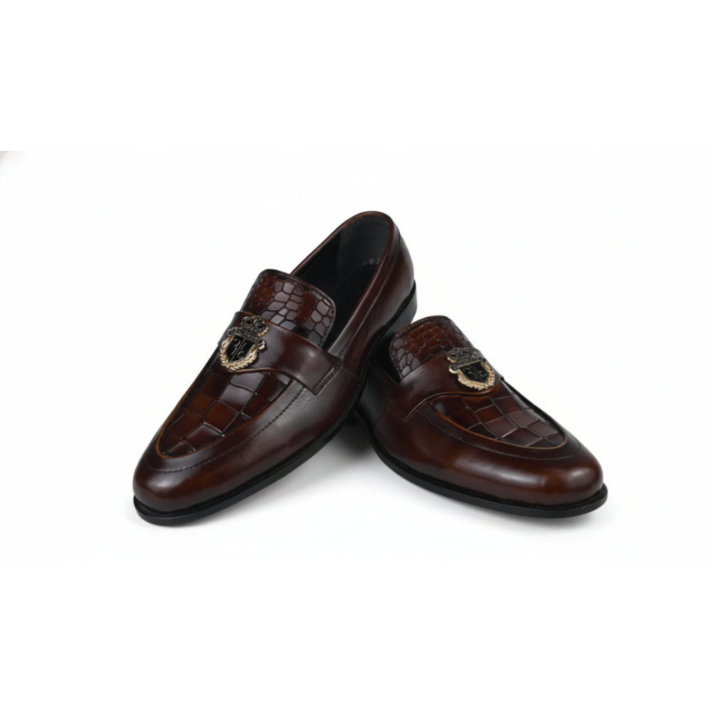 Pair of brown  loafers with decorative emblem on a white background